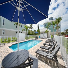 Pool with tables with umbrellas and lots of loungers